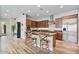 Modern kitchen featuring a large island, stainless steel appliances, granite counters and wood cabinets at 21014 W Cora Vista --, Buckeye, AZ 85396