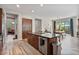Open-concept kitchen with stainless appliances, granite counters, wood cabinets, and adjacent dining area at 21014 W Cora Vista --, Buckeye, AZ 85396