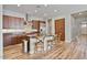Stylish kitchen with granite countertops, island seating, stainless steel appliances, and hardwood floors at 21014 W Cora Vista --, Buckeye, AZ 85396