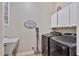 Functional laundry room with modern gray appliances, a utility sink, and storage cabinets at 21014 W Cora Vista --, Buckeye, AZ 85396