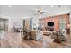 Bright living room featuring hardwood floors, a ceiling fan, and an open dining area at 21014 W Cora Vista --, Buckeye, AZ 85396
