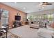 Cozy living room with large windows, plush seating, and a decorative fireplace, creating a relaxing atmosphere at 21014 W Cora Vista --, Buckeye, AZ 85396