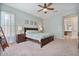 Spacious main bedroom with soft carpet, ceiling fan, and ensuite bathroom, offering a private oasis at 21014 W Cora Vista --, Buckeye, AZ 85396