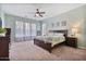 Serene main bedroom with soft carpet, ceiling fan, and natural light, providing a relaxing retreat at 21014 W Cora Vista --, Buckeye, AZ 85396