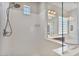 Shower featuring a mounted shower head, built-in shelves, and a view of the bathroom at 21014 W Cora Vista --, Buckeye, AZ 85396