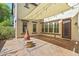 Backyard featuring a covered patio with string lights, outdoor fireplace and desert landscape offers relaxing outdoor living at 21104 W Sage Hill Rd, Buckeye, AZ 85396