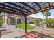 Expansive backyard with covered pergola, manicured lawn, desert landscaping, and sparkling pool at 21104 W Sage Hill Rd, Buckeye, AZ 85396