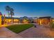 Spacious backyard with a relaxing pool, mature landscaping, patio area, and pergola with mountain views and custom lighting at 21104 W Sage Hill Rd, Buckeye, AZ 85396