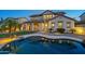 Inviting backyard pool with patio, reflecting the beauty of the surrounding house with landscape and outdoor lighting at 21104 W Sage Hill Rd, Buckeye, AZ 85396