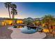 Beautiful backyard pool featuring a rock waterfall, mature palm trees, and ample space for entertaining with mountain views at 21104 W Sage Hill Rd, Buckeye, AZ 85396