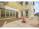An inviting backyard features a covered patio with string lights and outdoor fireplace, ideal for relaxing and entertaining at 21104 W Sage Hill Rd, Buckeye, AZ 85396