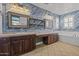 A stylish bathroom showcases dual vanities, rustic wood accent wall, bathtub and modern fixtures creating a spa-like retreat at 21104 W Sage Hill Rd, Buckeye, AZ 85396