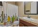 Cozy bathroom with stylish cactus-themed shower curtain, modern mirror, and neutral finishes at 21104 W Sage Hill Rd, Buckeye, AZ 85396