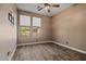 Empty bedroom showcasing wood-look floors, neutral walls, and natural light from two windows at 21104 W Sage Hill Rd, Buckeye, AZ 85396