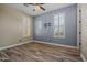 Bedroom featuring stylish shutters, wood flooring, neutral paint, and modern fixtures at 21104 W Sage Hill Rd, Buckeye, AZ 85396
