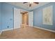 Bright bedroom with a connecting doorway, tile flooring, and a window with white shutters at 21104 W Sage Hill Rd, Buckeye, AZ 85396