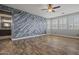 Spacious bedroom featuring a decorative wall, a ceiling fan, and modern flooring at 21104 W Sage Hill Rd, Buckeye, AZ 85396