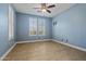 Clean and airy bedroom with a ceiling fan, natural light, and two windows with white shutters at 21104 W Sage Hill Rd, Buckeye, AZ 85396