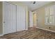 Sunny bedroom with wood-look floors, a ceiling fan and a large closet at 21104 W Sage Hill Rd, Buckeye, AZ 85396