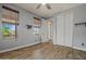 A naturally lit bedroom featuring light gray walls, wood-look flooring, and modern window coverings at 21104 W Sage Hill Rd, Buckeye, AZ 85396
