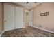 A charming bedroom featuring modern flooring, a ceiling fan, and spacious closet storage at 21104 W Sage Hill Rd, Buckeye, AZ 85396