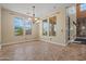 Bright dining room with tile floors, chandelier lighting, and windows with natural light at 21104 W Sage Hill Rd, Buckeye, AZ 85396