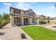Charming two-story home featuring a well-manicured lawn, covered porch, and neutral stucco exterior at 21104 W Sage Hill Rd, Buckeye, AZ 85396