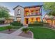 Charming two-story home boasting a welcoming front yard with lush landscaping and a second story balcony at 21104 W Sage Hill Rd, Buckeye, AZ 85396