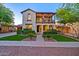 Charming two-story home boasting a welcoming front yard with lush landscaping and a second story balcony at 21104 W Sage Hill Rd, Buckeye, AZ 85396