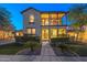 Charming two-story home boasting a welcoming front yard with lush landscaping and a second story balcony at 21104 W Sage Hill Rd, Buckeye, AZ 85396