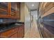 Hallway featuring a granite-topped wet bar, tiled floor, and accent wall at 21104 W Sage Hill Rd, Buckeye, AZ 85396