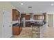This kitchen offers stainless steel appliances, rich wood cabinets, and a stone breakfast bar at 21104 W Sage Hill Rd, Buckeye, AZ 85396