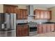 Kitchen features stainless appliances, mosaic tile backsplash, and wood cabinetry for a modern feel at 21104 W Sage Hill Rd, Buckeye, AZ 85396