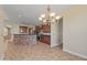 Kitchen boasts stainless steel appliances, breakfast bar, mosaic backsplash, and elegant lighting at 21104 W Sage Hill Rd, Buckeye, AZ 85396