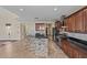 Bright kitchen featuring a breakfast bar with a stone base, tile backsplash, and stainless steel appliances at 21104 W Sage Hill Rd, Buckeye, AZ 85396