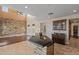 Open kitchen with breakfast bar, granite countertops, and views of the living room and natural light at 21104 W Sage Hill Rd, Buckeye, AZ 85396