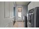 Well-lit laundry room with a modern washer/dryer set and access to the backyard at 21104 W Sage Hill Rd, Buckeye, AZ 85396