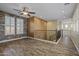 Open living room with decorative brick wall, wood-look floors and a ceiling fan at 21104 W Sage Hill Rd, Buckeye, AZ 85396