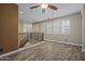Open living area with wood-look flooring, lots of natural light and a staircase view at 21104 W Sage Hill Rd, Buckeye, AZ 85396