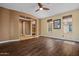 A spacious living room featuring hardwood flooring, neutral walls, and a seamless entry into other rooms at 21104 W Sage Hill Rd, Buckeye, AZ 85396