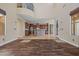 Open living room with hardwood floors, view of the kitchen, and a grand balcony at 21104 W Sage Hill Rd, Buckeye, AZ 85396