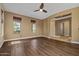 A spacious living room featuring hardwood flooring, neutral walls, and a seamless entry into other rooms at 21104 W Sage Hill Rd, Buckeye, AZ 85396