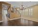 Well-lit living room with hardwood floors, plantation shutters, and a stairway at 21104 W Sage Hill Rd, Buckeye, AZ 85396