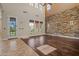 Bright living room boasting tall windows, hardwood floors, and an accent stone wall at 21104 W Sage Hill Rd, Buckeye, AZ 85396