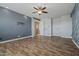 Spacious living room featuring tile floors, ample natural light, and stairs to an upper level at 21104 W Sage Hill Rd, Buckeye, AZ 85396
