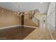 Spacious living room featuring hardwood floors, chandelier, and stairway access to the second level at 21104 W Sage Hill Rd, Buckeye, AZ 85396