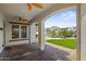 Covered patio offers a view of a serene backyard with lush grass, a sparkling pool, and mountain views at 21104 W Sage Hill Rd, Buckeye, AZ 85396