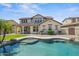 Gorgeous two-story home with a lovely pool, desert landscaping, and well-manicured lawn at 21104 W Sage Hill Rd, Buckeye, AZ 85396