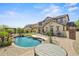 Stunning backyard featuring a gorgeous pool, covered patio, lush lawn, and desert landscaping at 21104 W Sage Hill Rd, Buckeye, AZ 85396