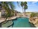 Private pool area with lush landscaping including palms, mature trees, and desert plants at 21104 W Sage Hill Rd, Buckeye, AZ 85396